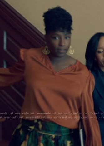 Nova's orange split-neck blouse on Queen Sugar