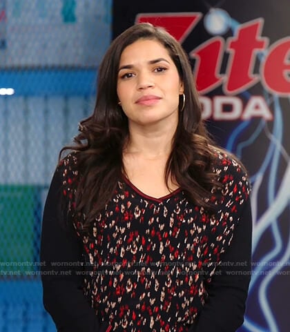 Amy's black printed v-neck top on Superstore