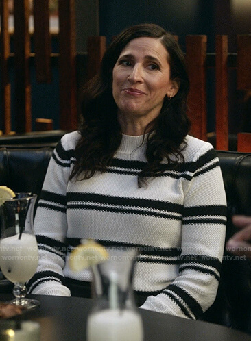 Delia's black and white striped knit sweater on The Unicorn
