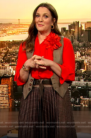 Drew's orange tie neck blouse and plaid skirt on The Drew Barrymore Show
