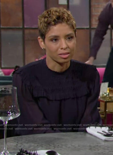 Elena's navy ruffled trim blouse on The Young and the Restless