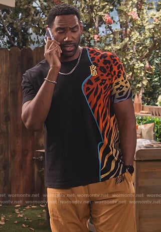 Moz's black animal print tee on Family Reunion