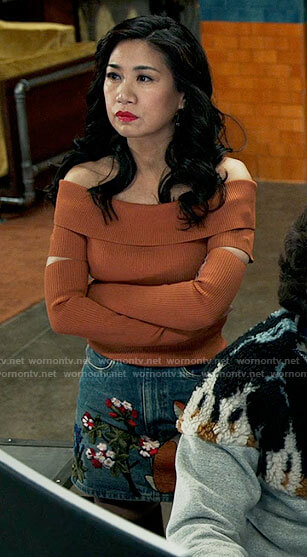 Mel's orange off-shoulder top and embroidered denim skirt on The Equalizer