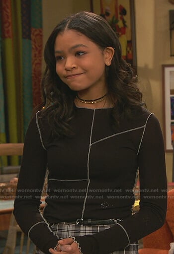 Nia's black top with white stitching on Ravens Home