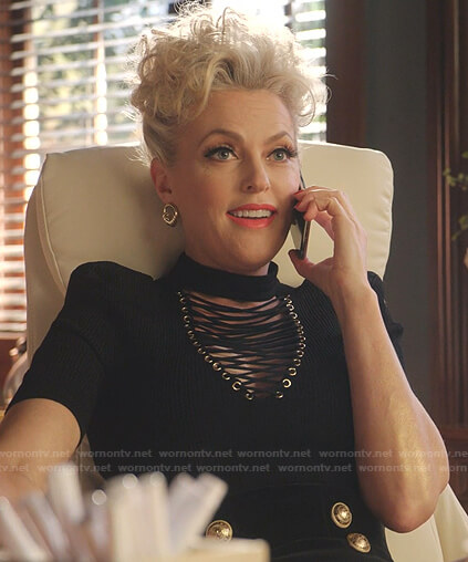 Alexis's black lace-up top and skirt with gold buttons on Dynasty