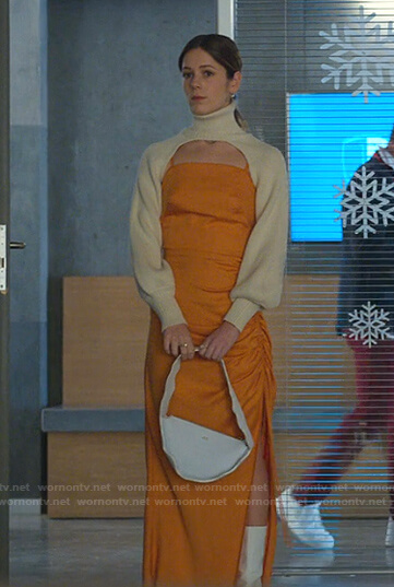 Cayetana’s orange ruched dress and cream turtleneck cropped sweater on Elite