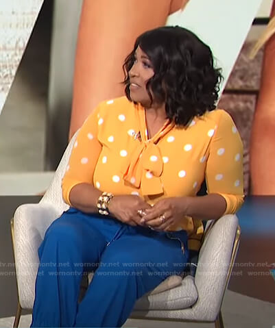 Kym's yellow polka dot top and blue pants on E! News Daily Pop