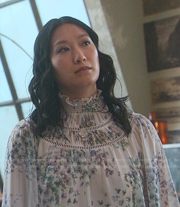 Sumi's white floral ruffle neck blouse on Good Trouble