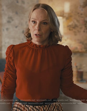 Jan's red ruched sleeve top on Only Murders in the Building