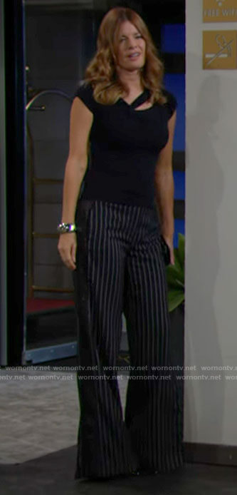 Phyllis's navy asymmetric cutout top and pinstripe pants on The Young and the Restless