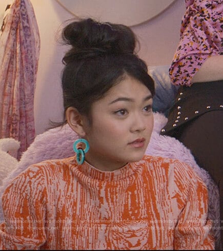 Claudia's orange printed top on The Baby-Sitters Club
