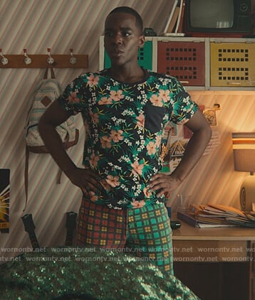 Eric's multicolored check pants and floral tee on Sex Education