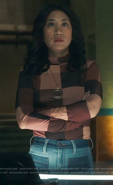 Mel's checked turtleneck top and patch pocket jeans on The Equalizer