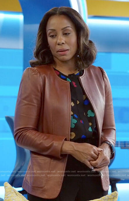 Mia's multicolored print blouse and leather jacket on The Morning Show