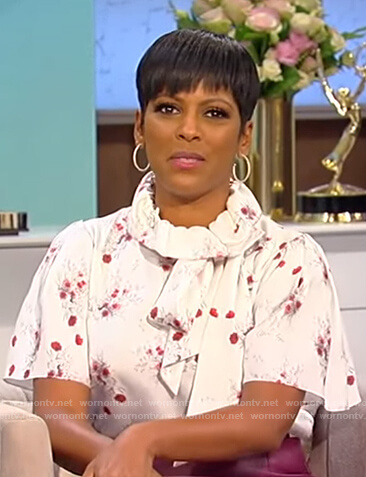 Tamron's white floral print blouse and purple skirt on Tamron Hall Show