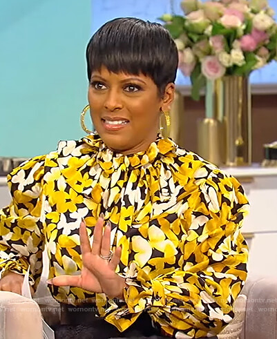 Tamron's yellow floral print tie neck blouse on Tamron Hall Show