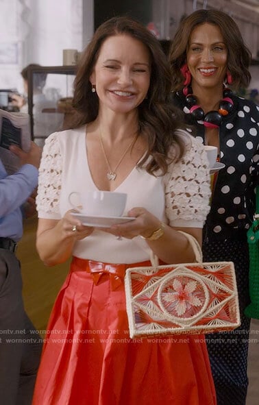 Charlotte's floral crochet sleeve top and red skirt on And Just Like That