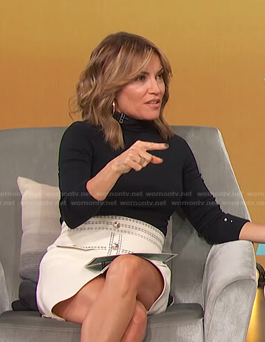 Kit's black top and white skirt with contrast stitching on Access Hollywood