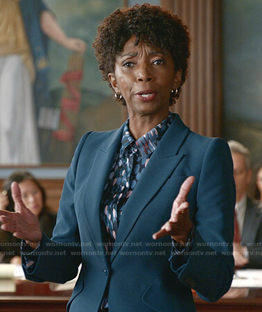 Olivia's teal green suit and dot print shirt on Bull