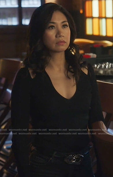 Mel's black cutout shoulder top and studded jeans on The Equalizer