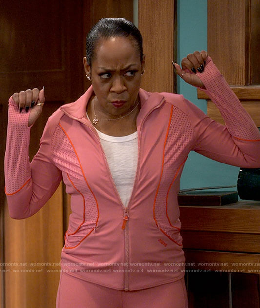 Tina's pink active jacket and leggings on The Neighborhood