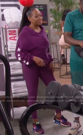 Tina's purple star print hoodie and leggings on The Neighborhood