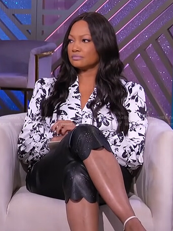 garcelle's whtie floral top and black scalloped hem pants on The Real