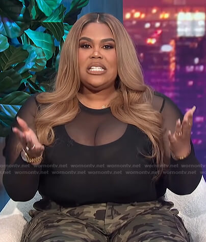 Nina's black mesh top and camo pants on E! News Nightly Pop