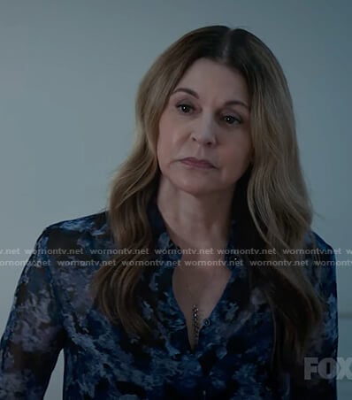 Kit's black and blue abstract print blouse on The Resident