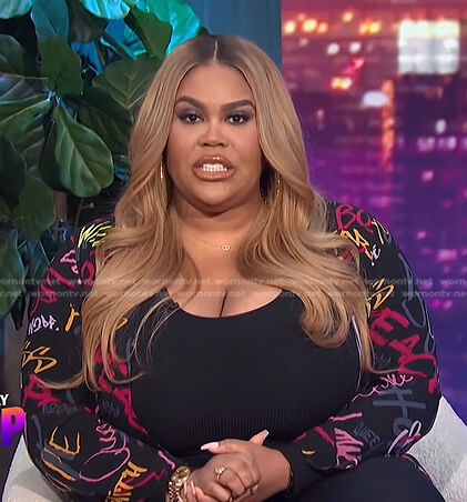 Nina's black jumpsuit and printed sheer kimono on E! News Nightly Pop