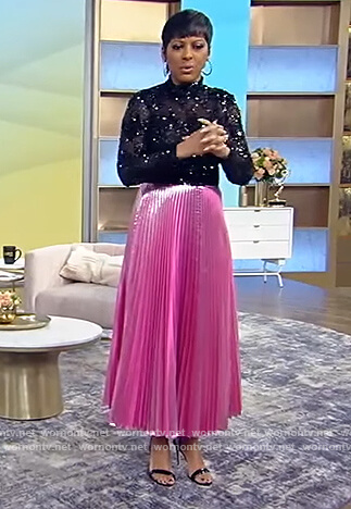 Tamron's black sequin top and pink pleated skirt on Tamron Hall Show