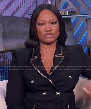 Garcelle's black blazer with gold contrast trim on The Real