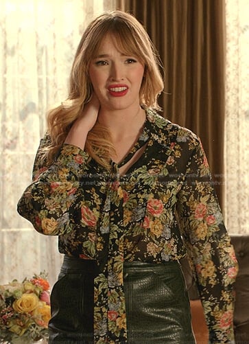 Kirby's black floral tie neck blouse and green leather skirt on Dynasty