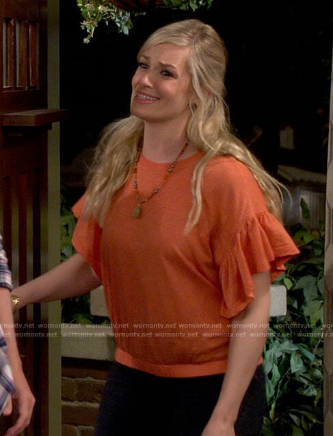 Gemma's orange ruffled sleeve top on The Neighborhood