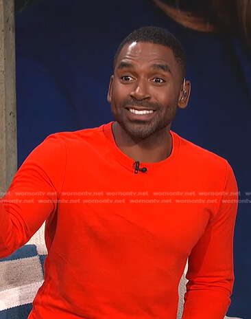 Justin's red fitted sweater on E! News Daily Pop