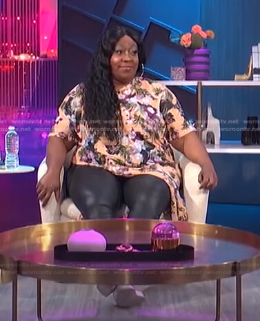 Loni's orange floral short sleeve top on E! News Nightly Pop