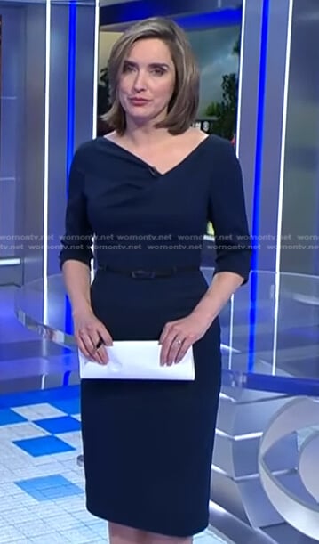 Margaret’s navy asymmetric neckline dress on CBS Evening News