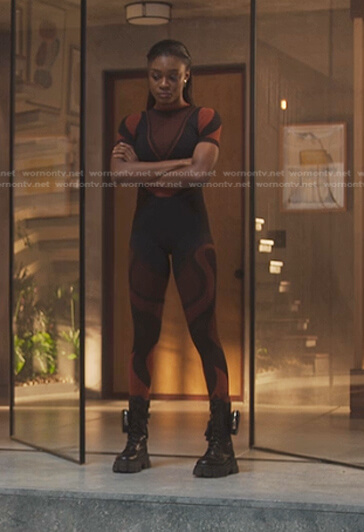 Cal's orange and black colorblock top and leggings on First Kill