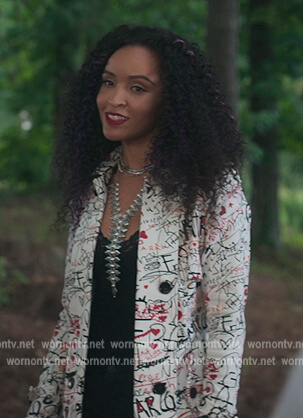 Carmen's white graffiti print coat on First Kill