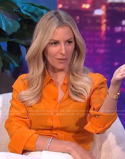 Morgan's orange button down blouse on E! News Nightly Pop