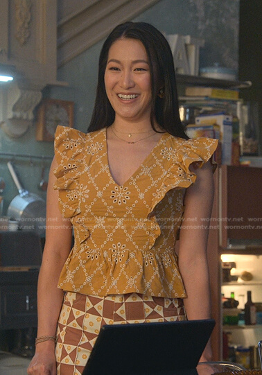 Sumi's yellow eyelet ruffle top and check pants on Good Trouble