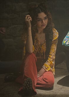Flora's yellow floral top and black studded vest on Fate The Winx Saga