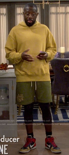 Malcolm's green shorts and Nike sneakers on The Neighborhood