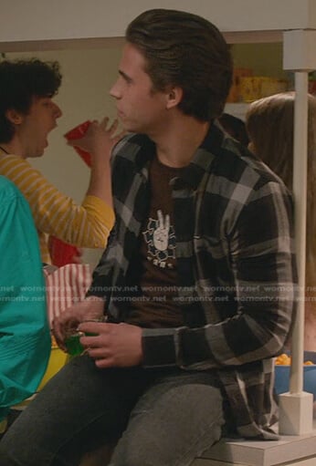 Robby's brown print tee and black plaid shirt on Cobra Kai