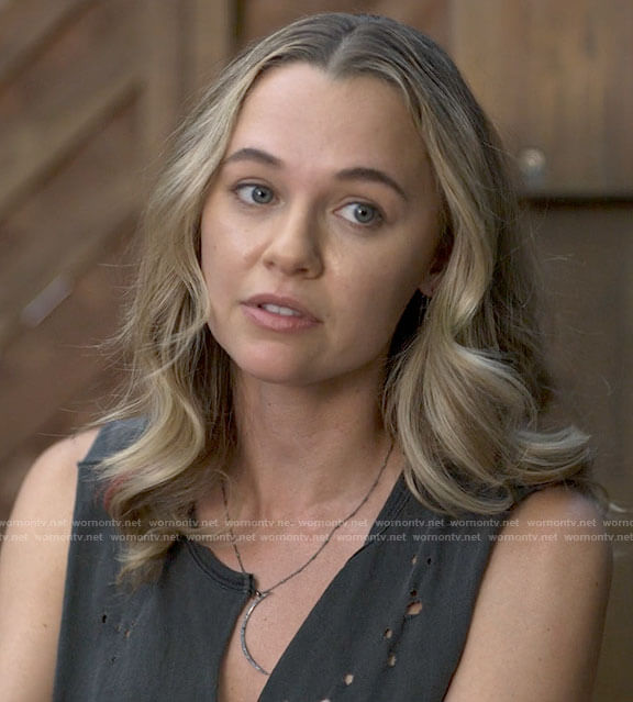 Sam's black distressed tank top and white boots on American Horror Stories