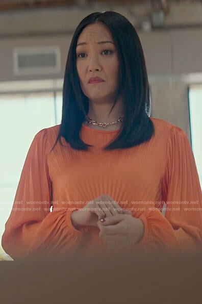 Chloe's orange pleated dress on From Scratch
