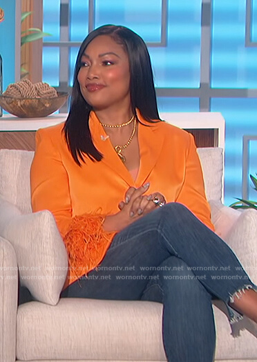 Garcelle Beauvais's orange feather cuff blazer on The Talk