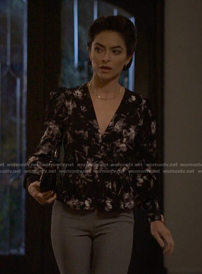Sarah's black printed v-neck top on Reasonable Doubt