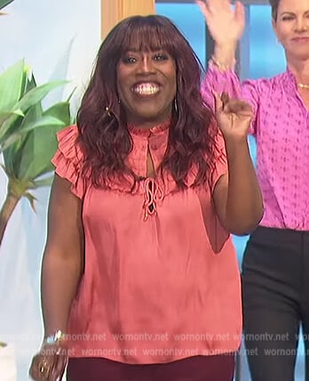Sheryl's coral satin ruffle blouse on The Talk