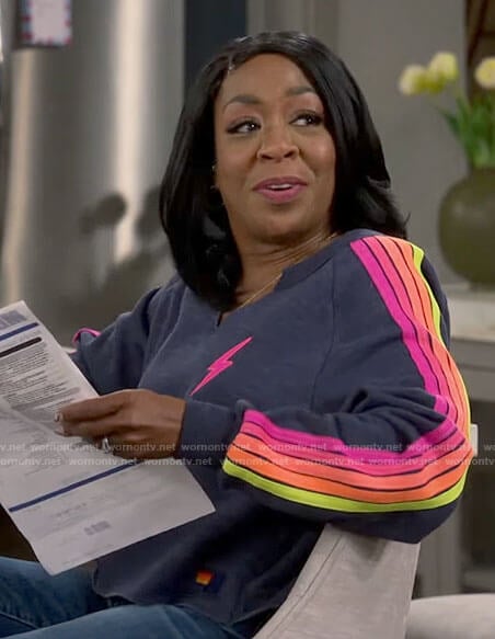 Tina's bolt and stripe sleeve sweatshirt on The Neighborhood